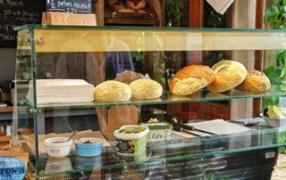 Bread rolls and other food items on display at the café counter
