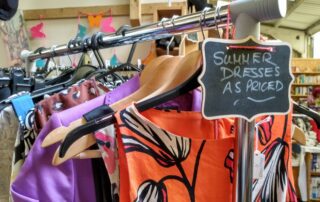 Summer dresses on a clothes rail in the charity shop