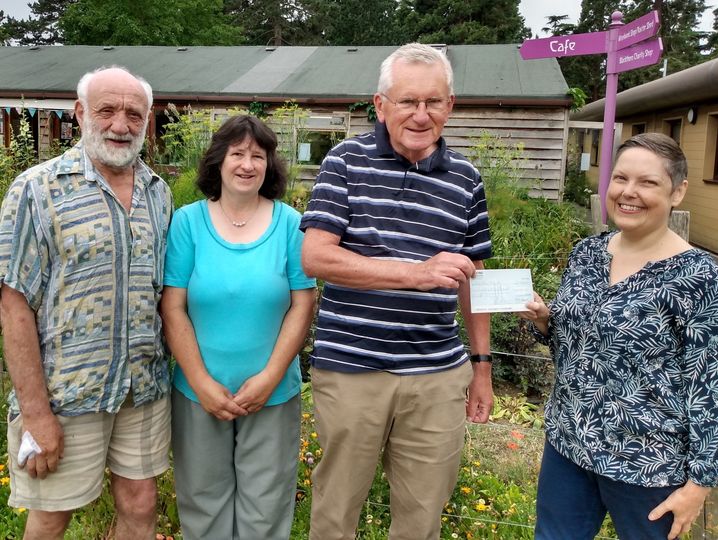 Three people from the Fant and Bower Community Group handing over a cheque to Louisa Langford from the Blackthorn Trust